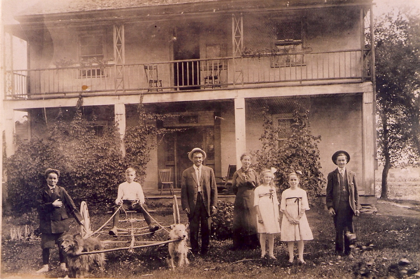 Oliver Nicholas Sparks and family at his home on Concession 4, lot 23, Huntley Township, c.1914. Oliver Nicholas Sparks family from left to right are Walter, Harold, Nicholas, Emma (Owens), Kathleen, Helena, and Ledger (died in Canadian Army WWI). At that time it was the Smith Hotel/Tavern north
of Carp.